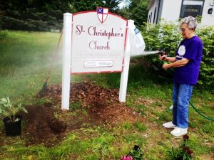 Marge Hull preparing the earth for its flowers at St Chris
